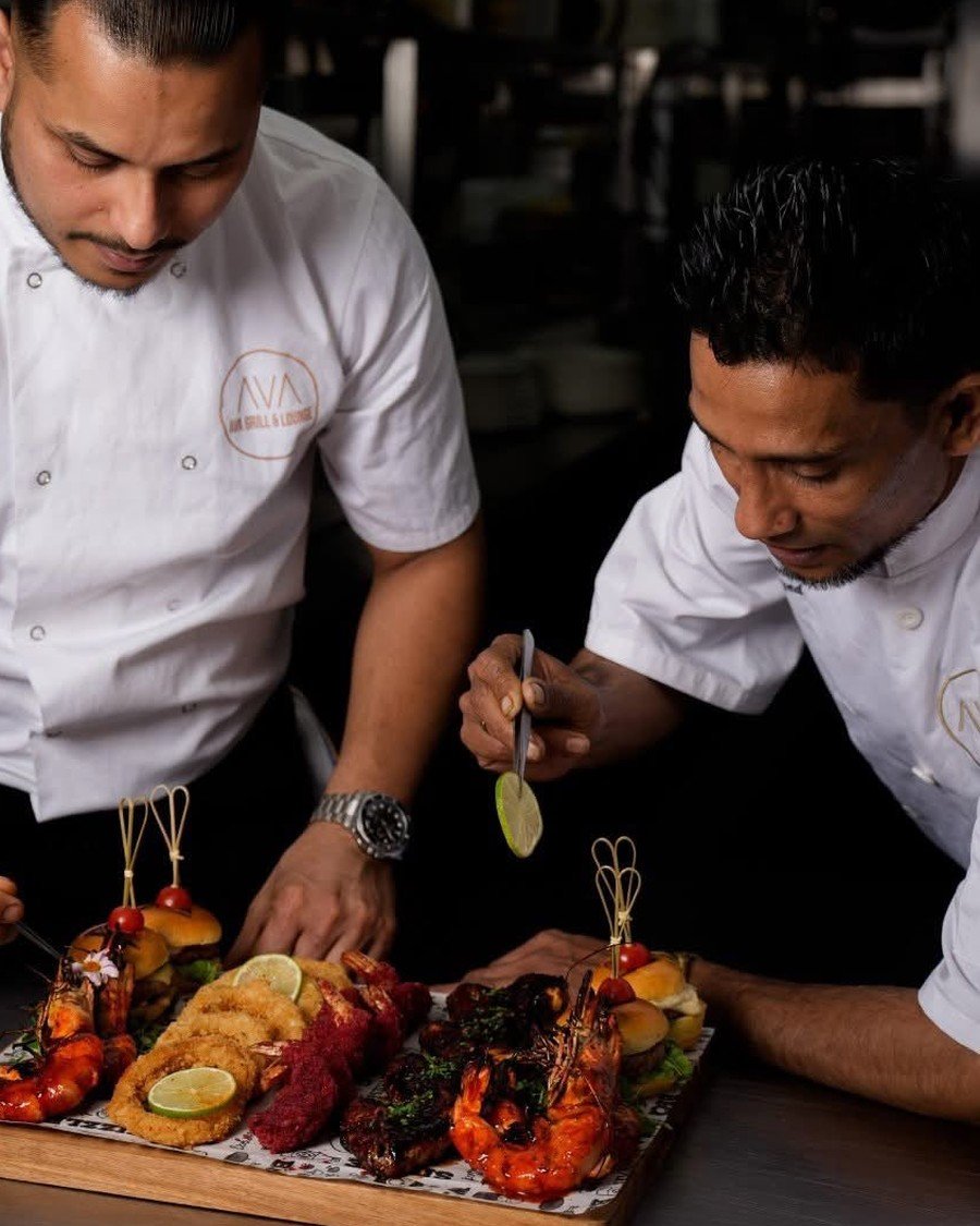 Chef Rasel finishing a seafood platter in the AVA kitchen