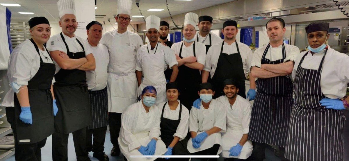 The kitchen brigade lined up in whites