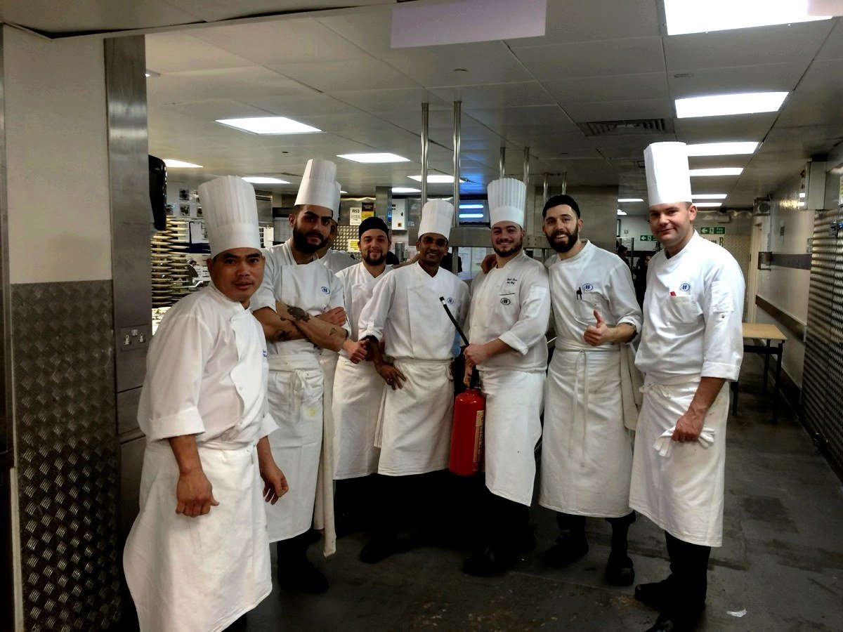 A five-star hotel brigade in tall toques